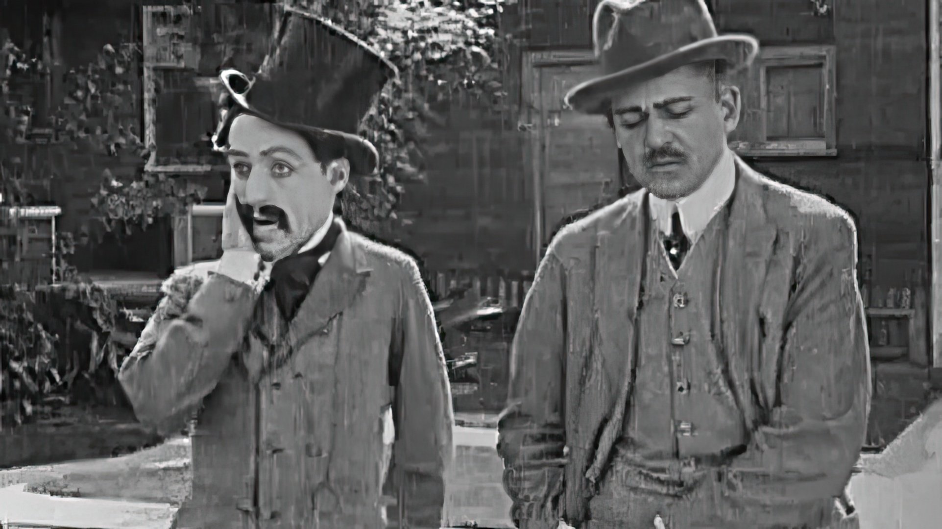 Charlie Chaplin's first film role (left)