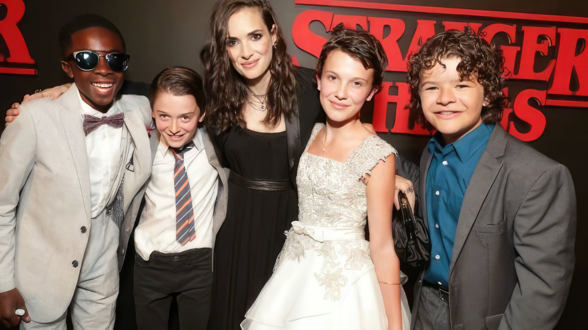 Millie Bobby Brown with colleagues on the series set