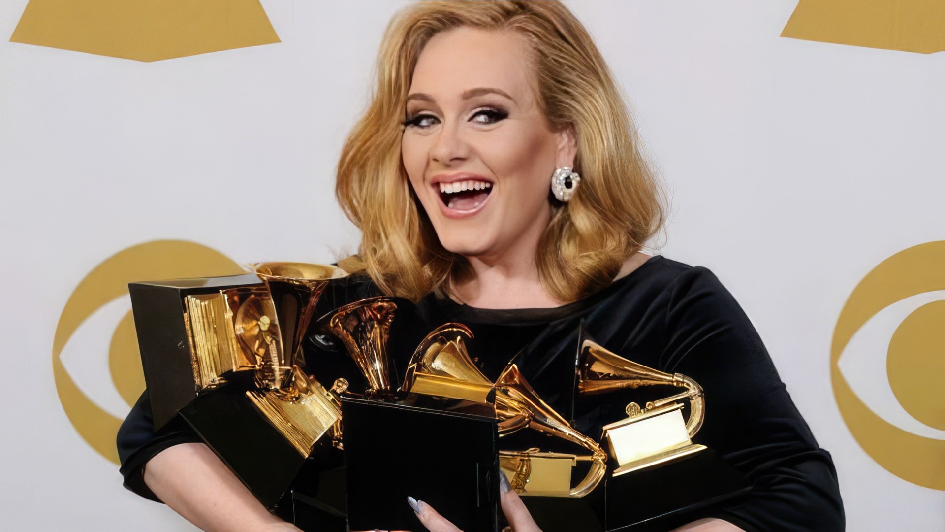 Adele beats records of 