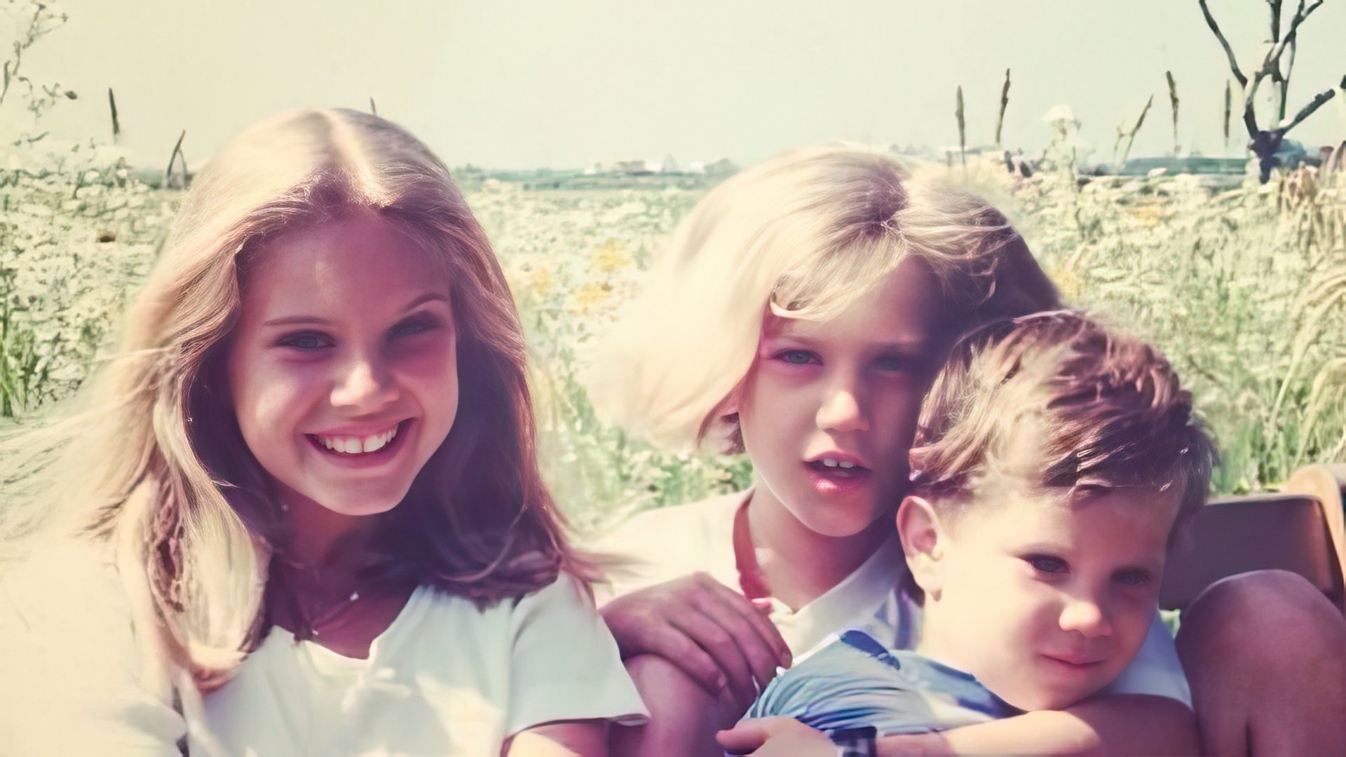 Lana Del Rey in her childhood (pictured left with her brother and sister)