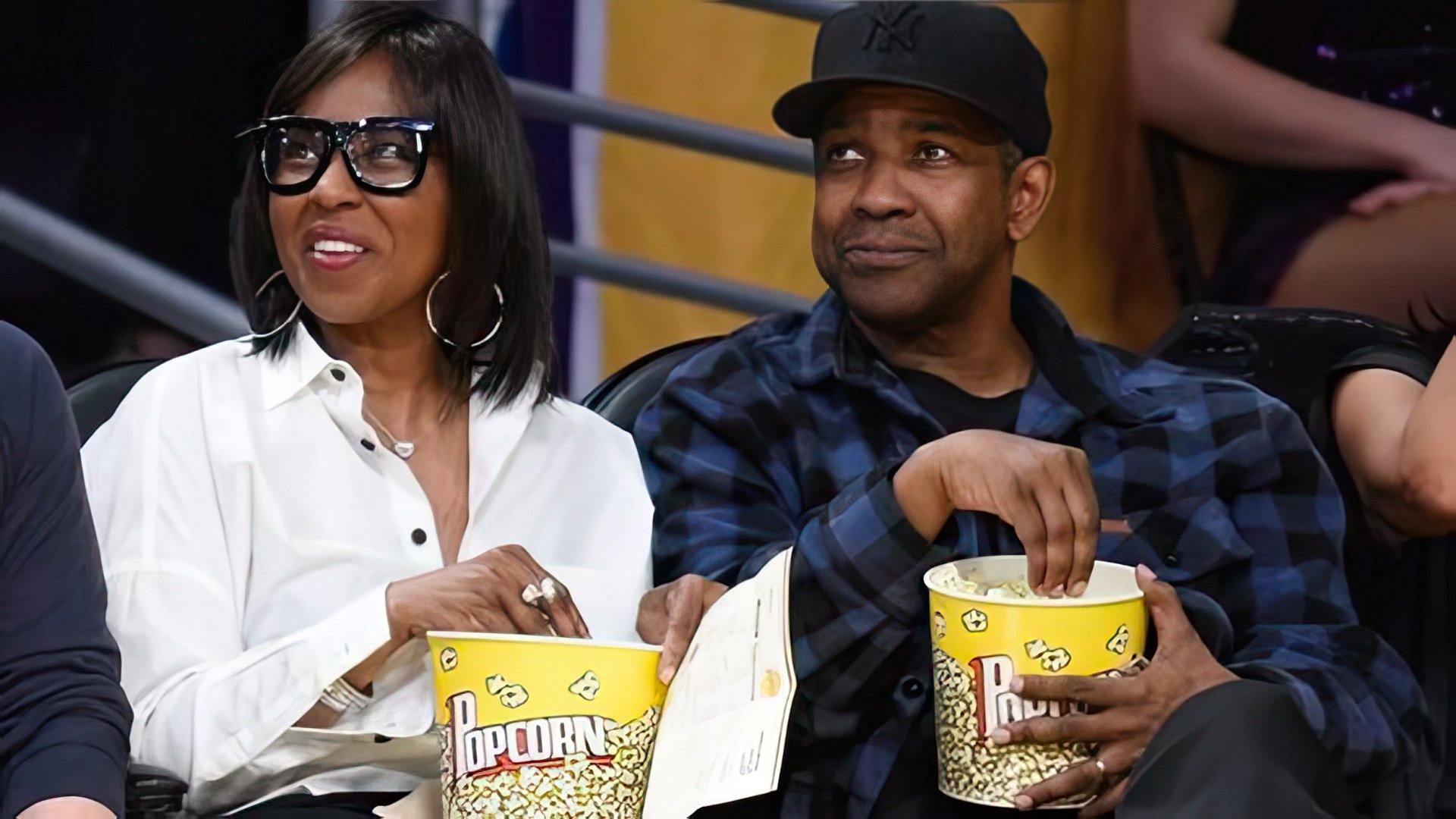 Denzel Washington and his wife at a basketball match
