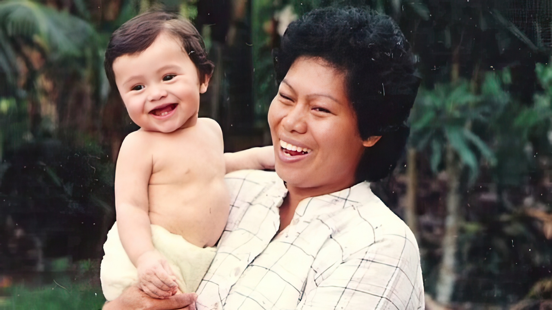 Henry Golding as a child with his mother