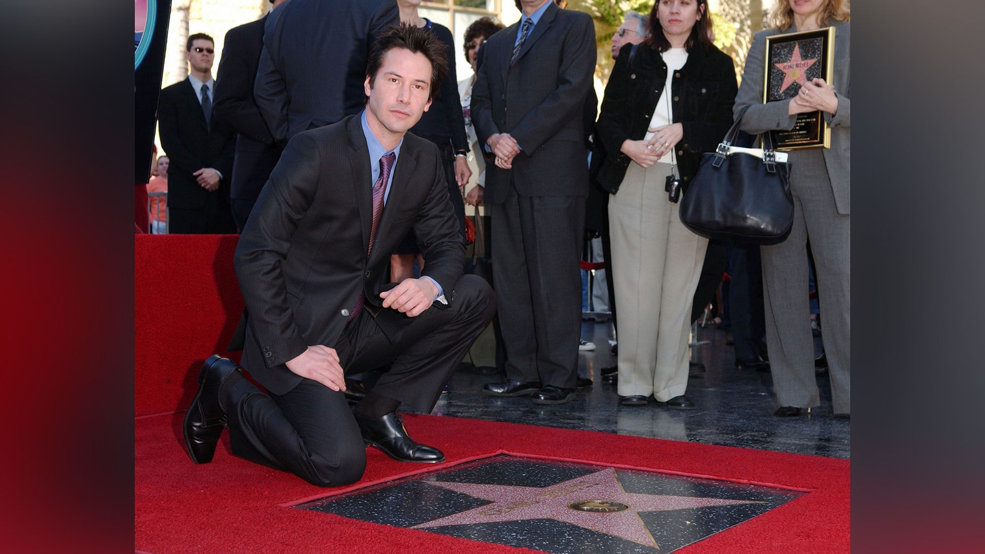 Keanu Reeves with his star on the Hollywood Walk of Fame