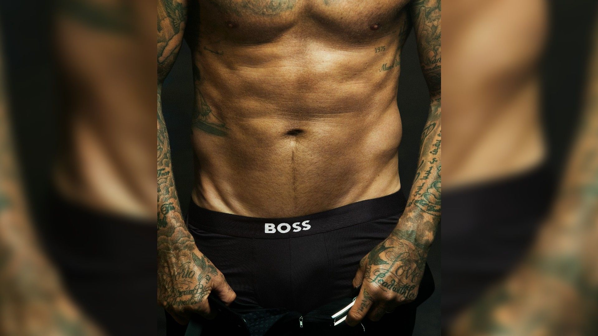 A man in black boxers with defined abs in close-up