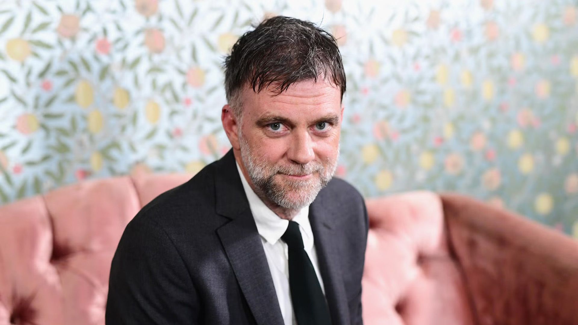Director Paul Thomas Anderson sits on a pink couch