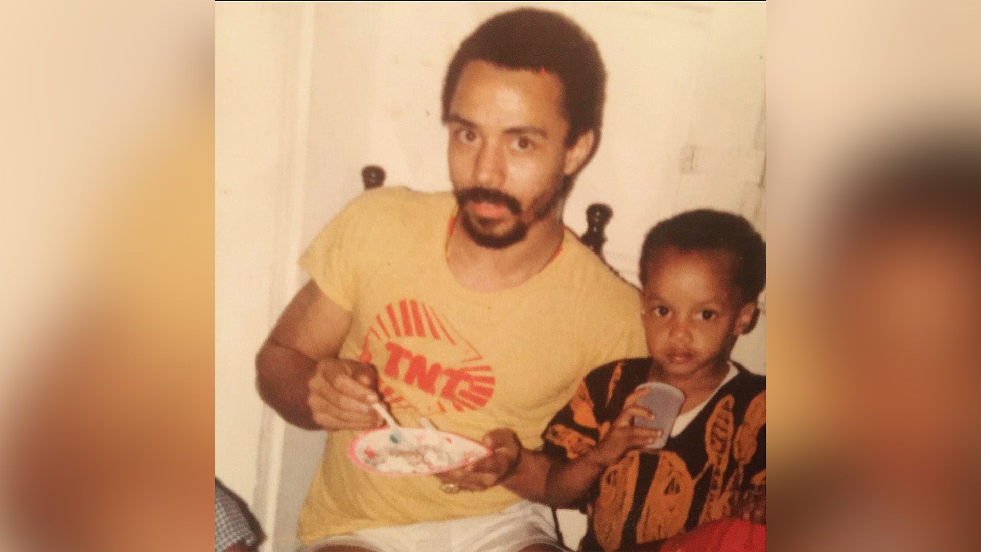 Donald Faison as a child standing next to his father