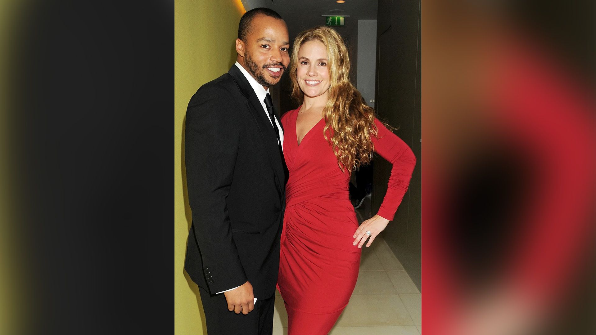 Donald Faison in a black blazer and CaCee Cobb in a long red dress