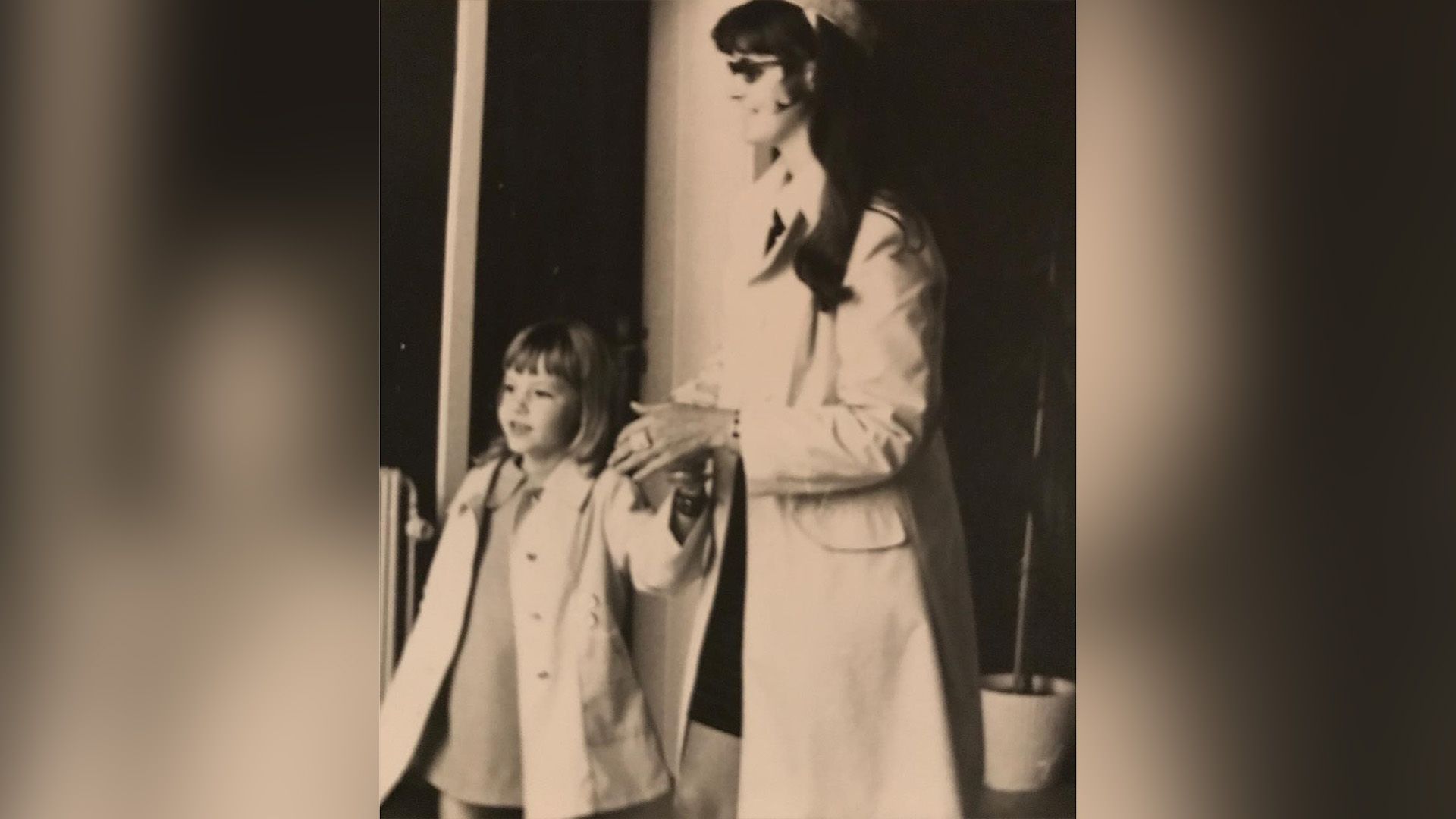 Connie Nielsen as a child holding her mother's hand