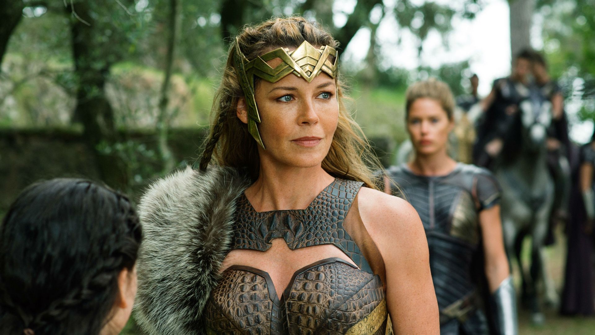Connie Nielsen in leather armor and a golden Amazon crown