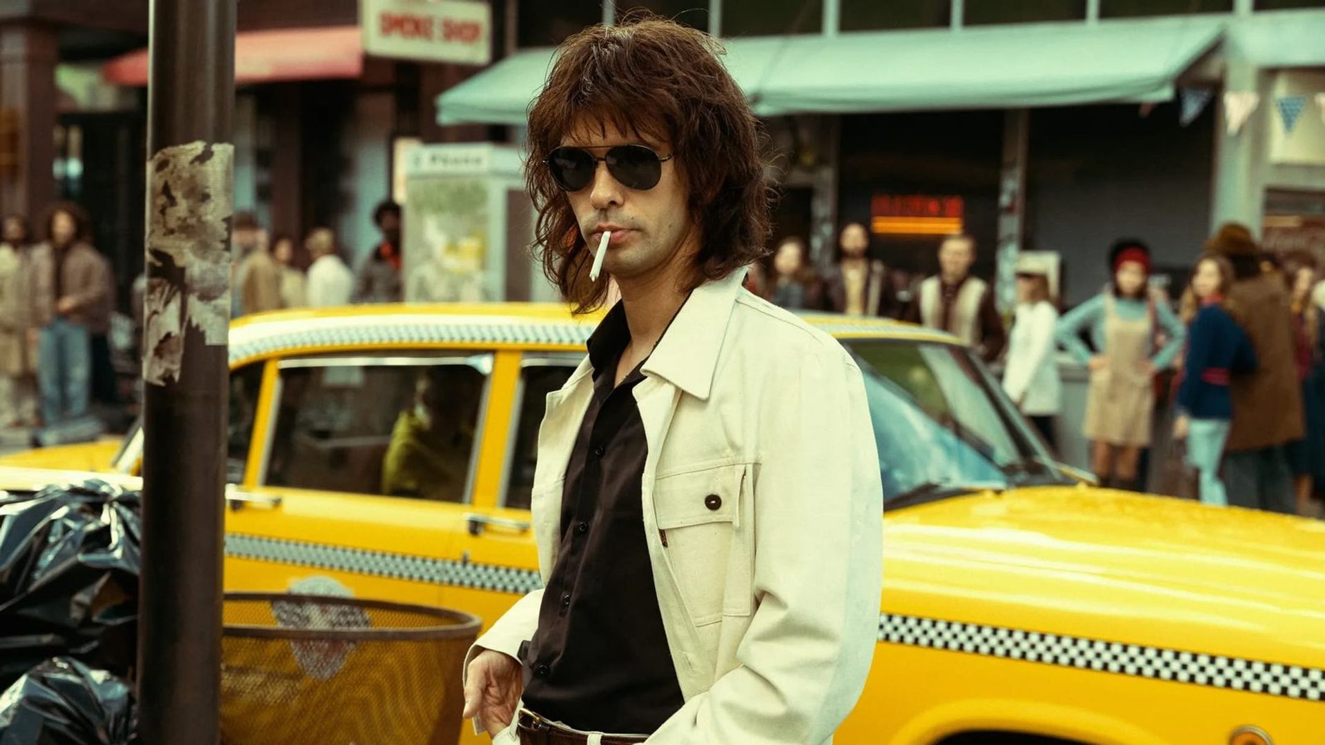 Ben Whishaw in a long wig and aviator glasses, still from Limonov
