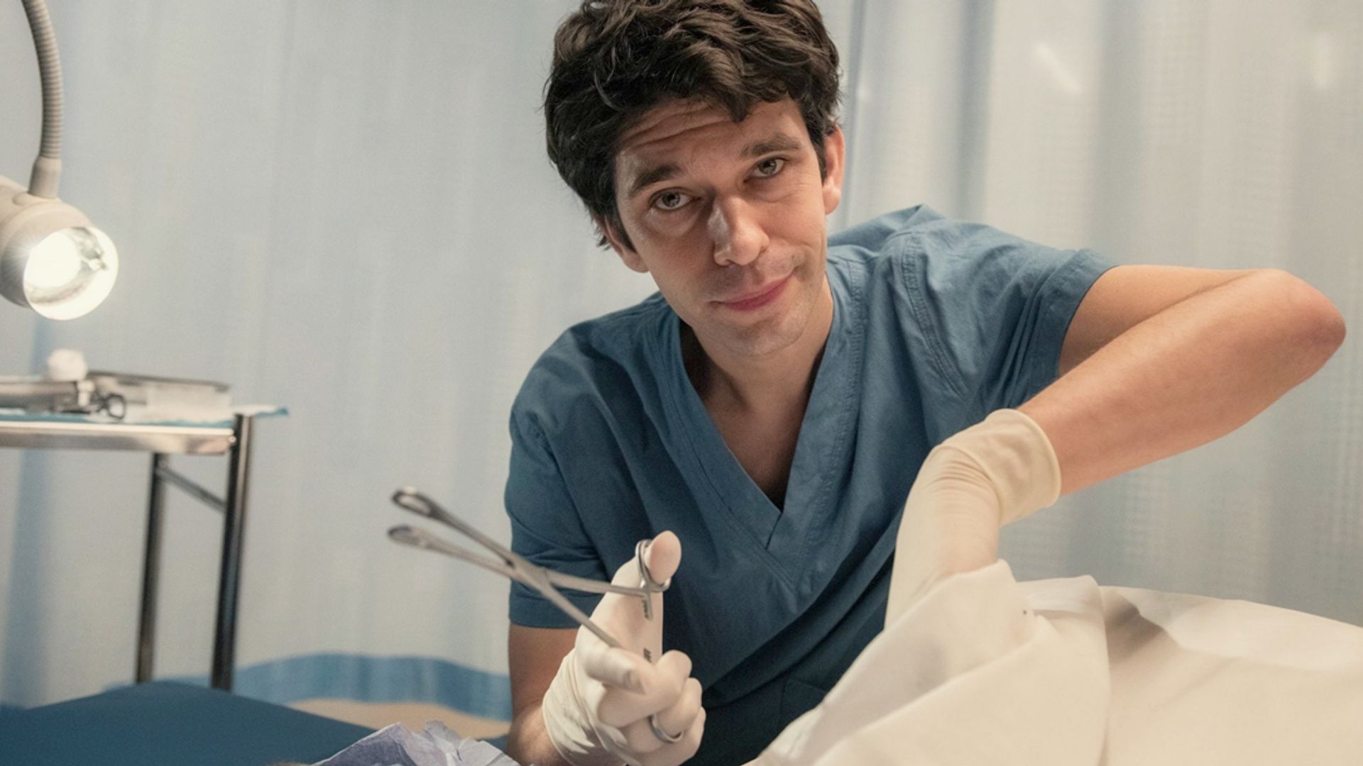 Ben Whishaw in doctor's scrubs holding a medical instrument, still from the series This Is Going to Hurt