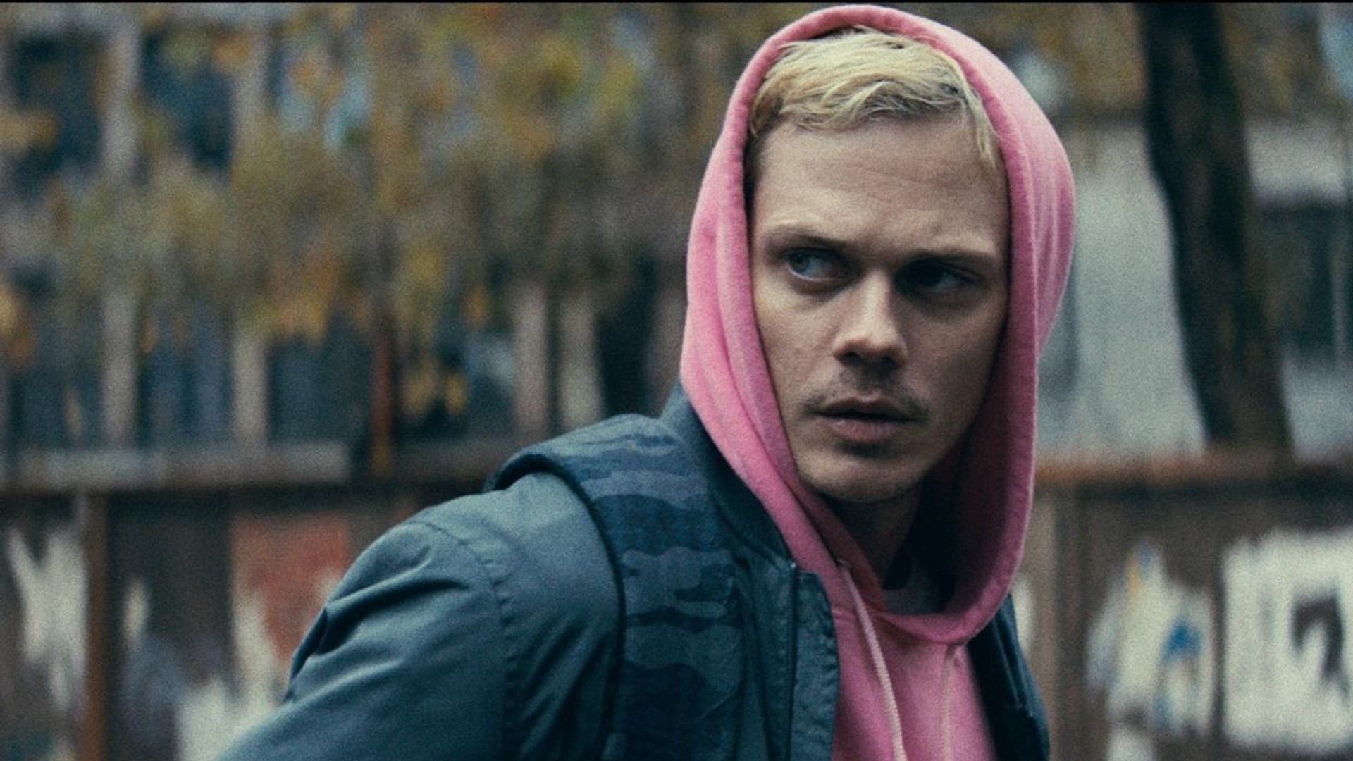 Bill Skarsgård in a pink hoodie