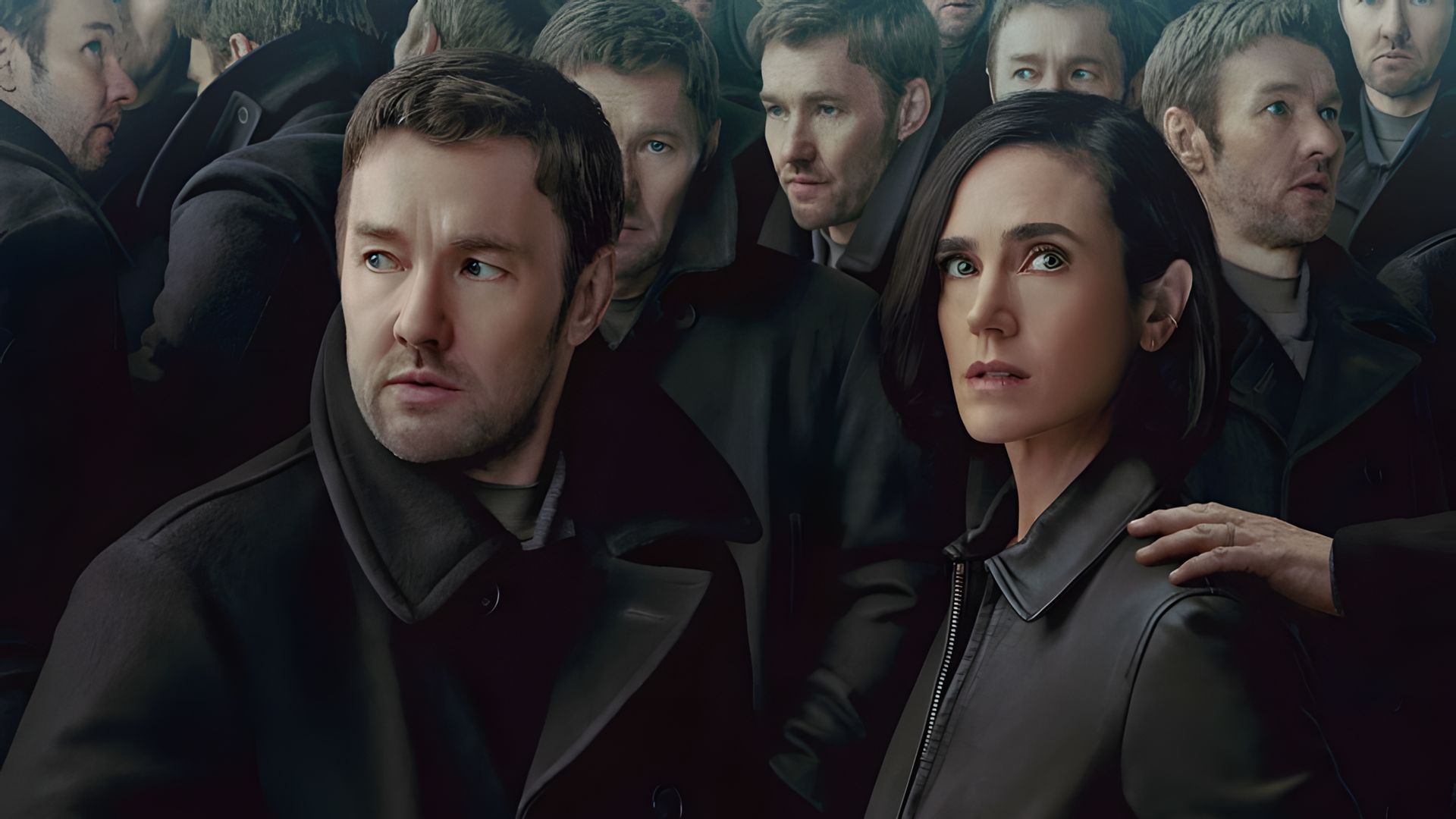 Joel Edgerton and Jennifer Connelly in outerwear standing in a crowd