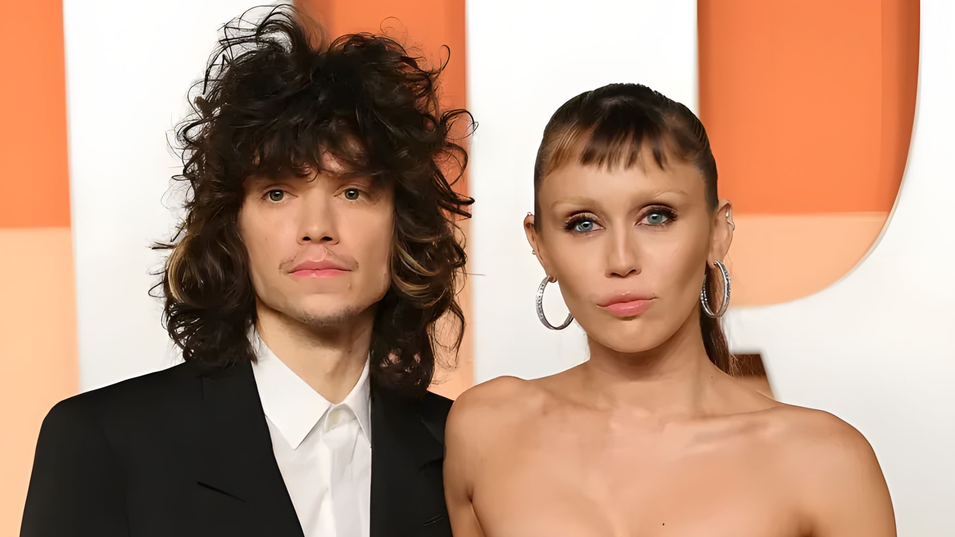 Miley Cyrus and Maxx Morando pose on the red carpet