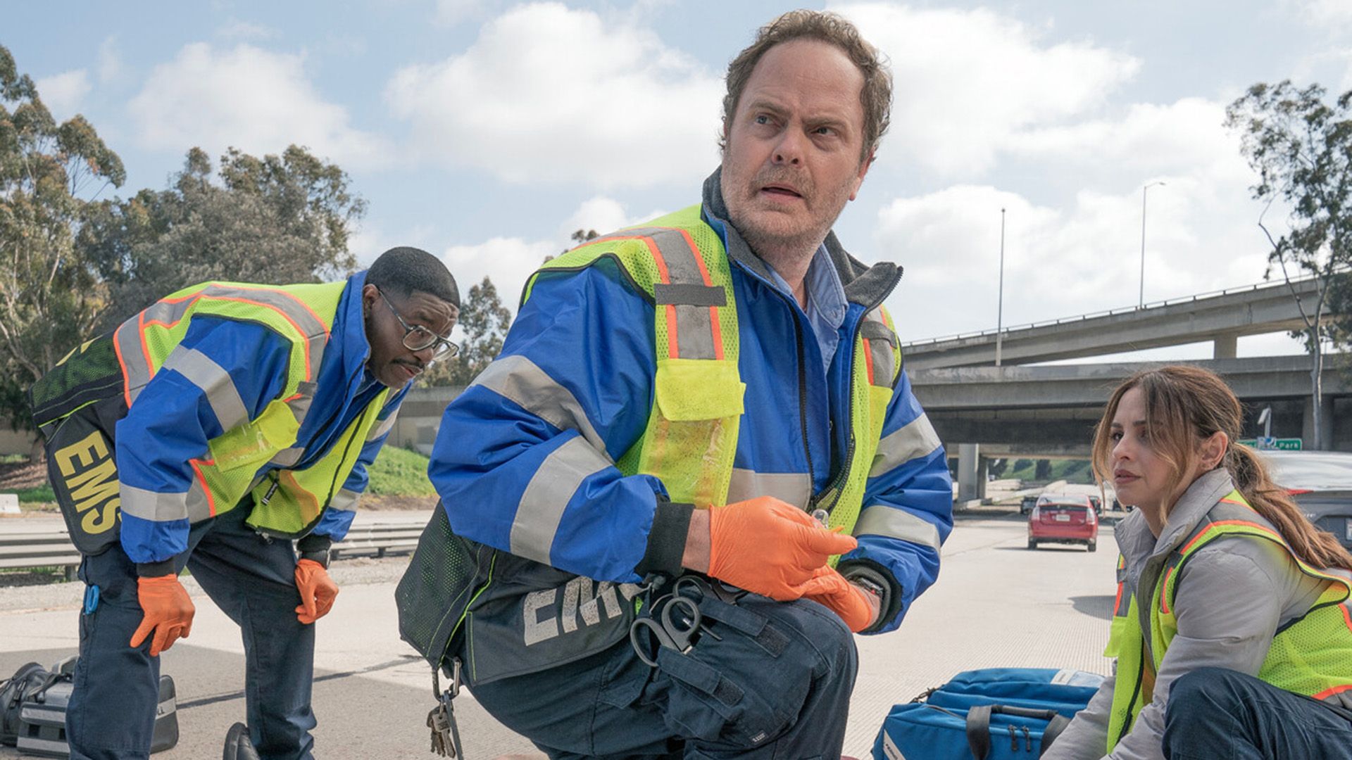 Rainn Wilson in paramedic uniform looking concerned