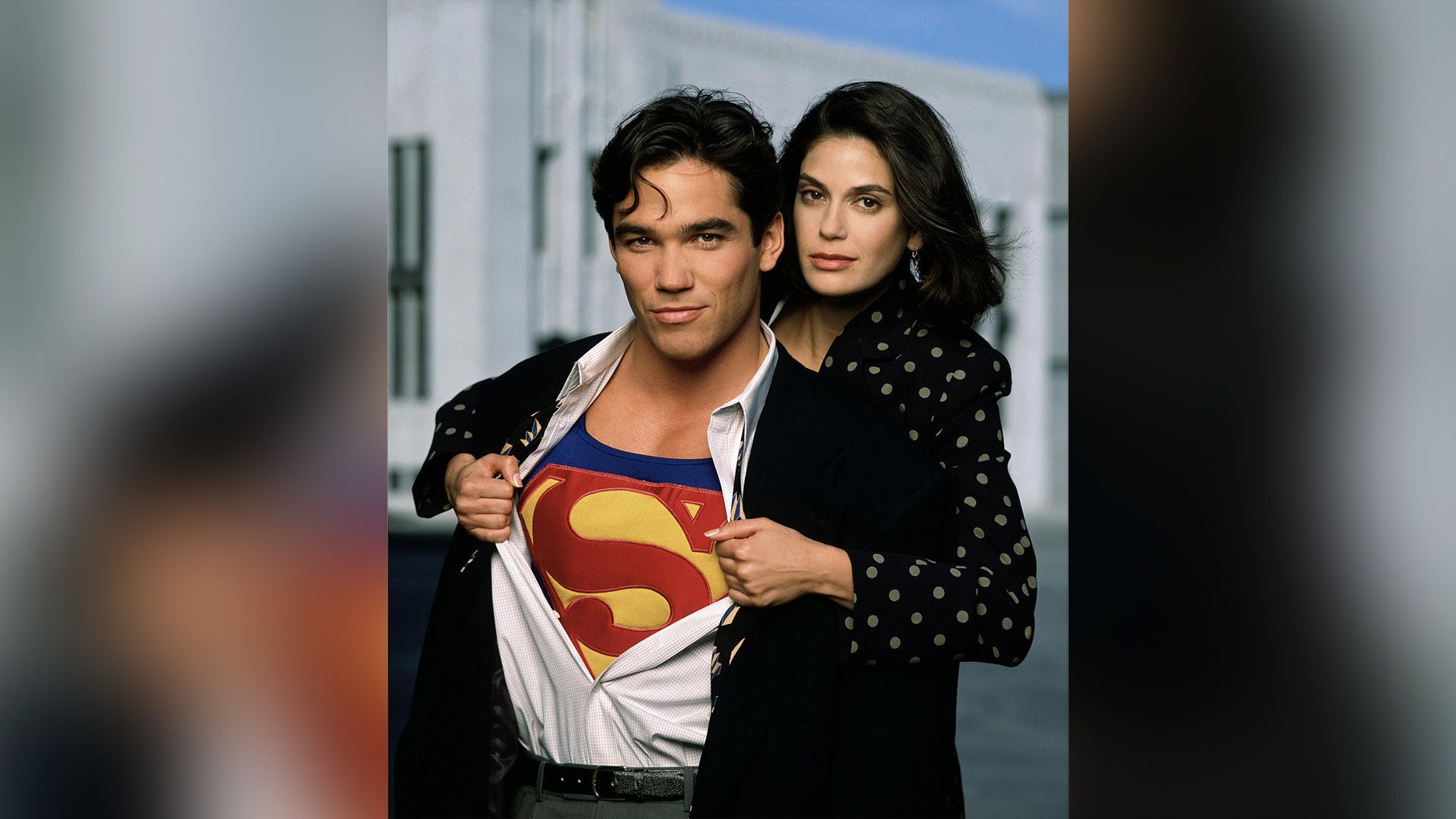 Teri Hatcher hugs Dean Cain around the shoulders as he reveals his Superman costume under his shirt