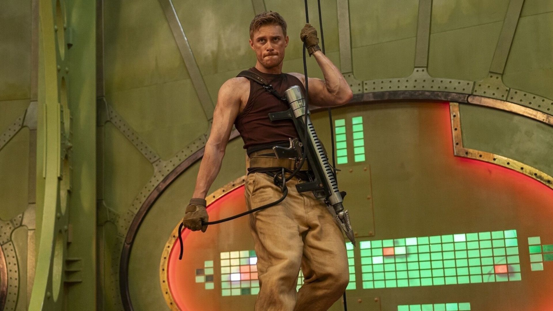 Max Parker with an assault rifle at the ready descends on a rope from the ceiling