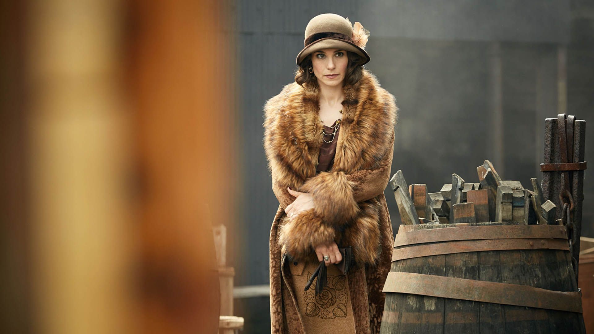 Charlotte Riley in a beige hat and beige coat with voluminous ginger fur