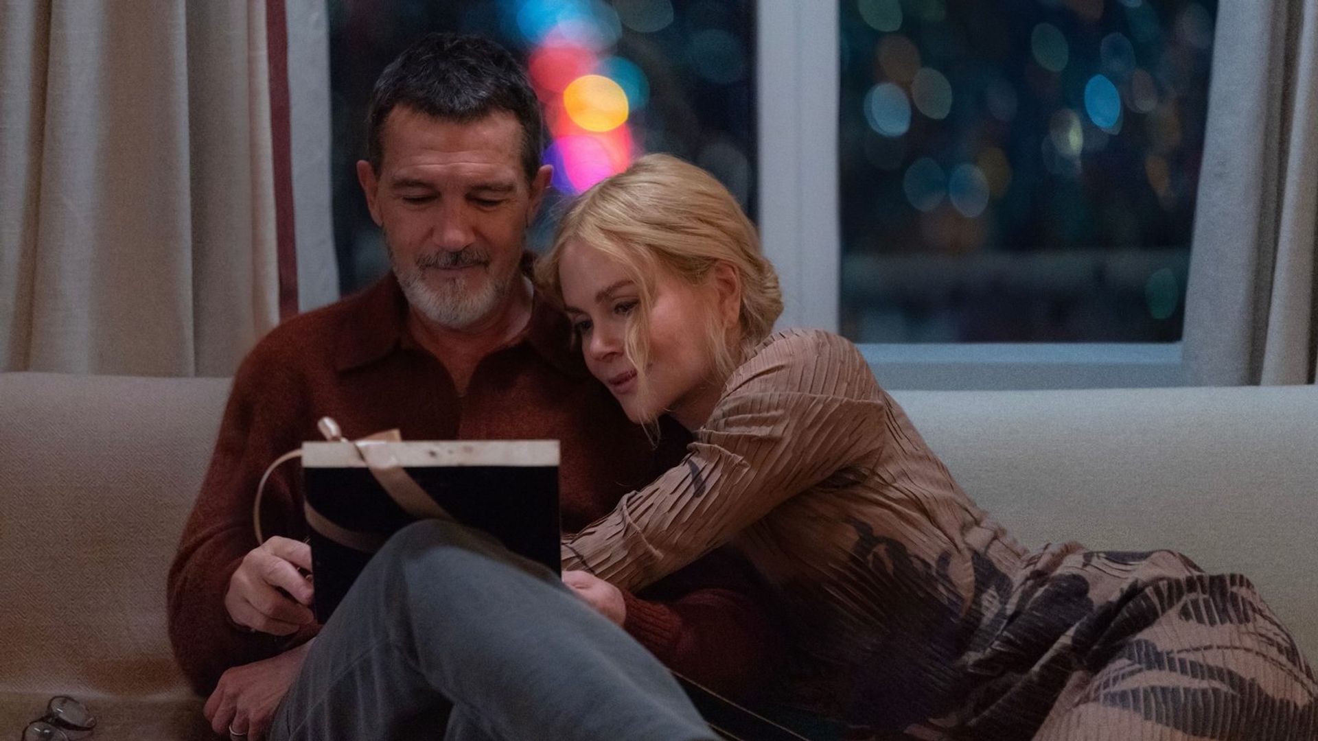 Antonio Banderas and Nicole Kidman sitting on a couch embracing, a scene from the film