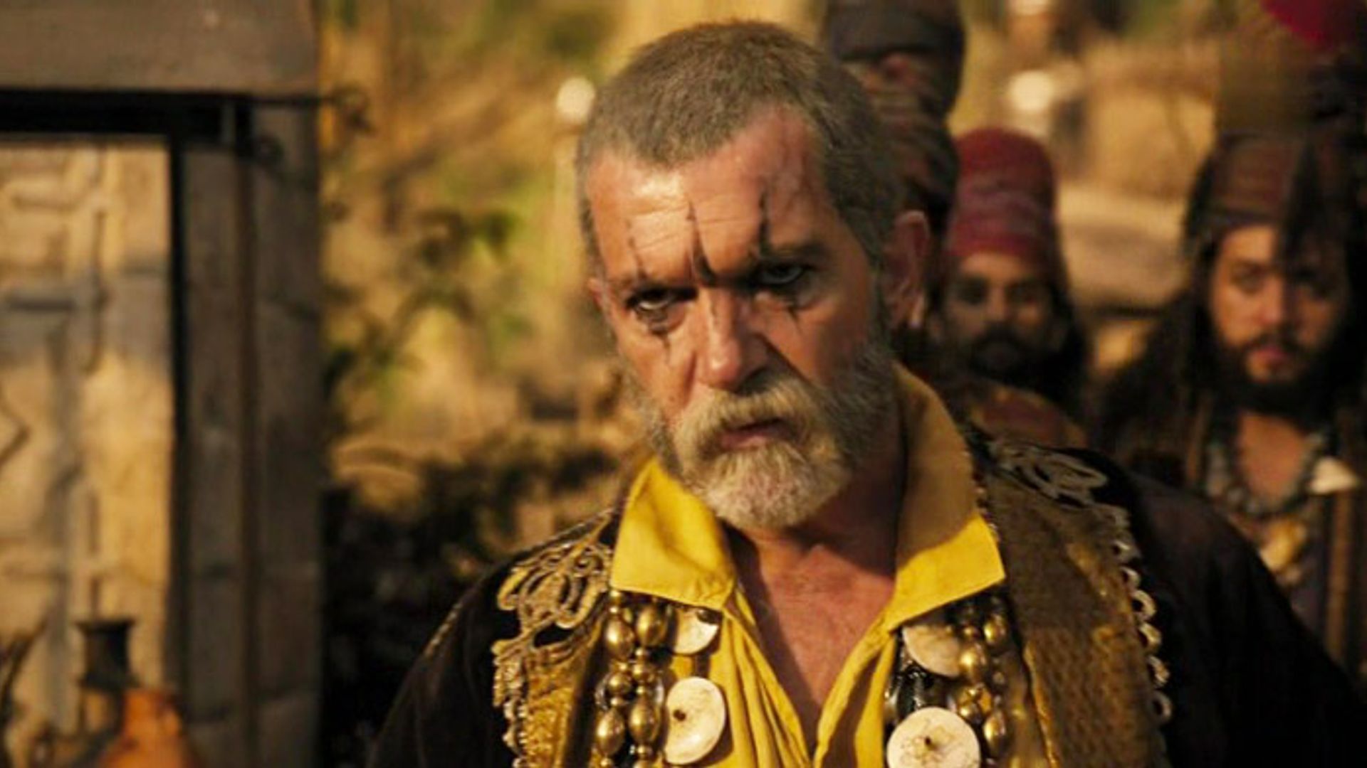 Antonio Banderas bald, in makeup, with a beard