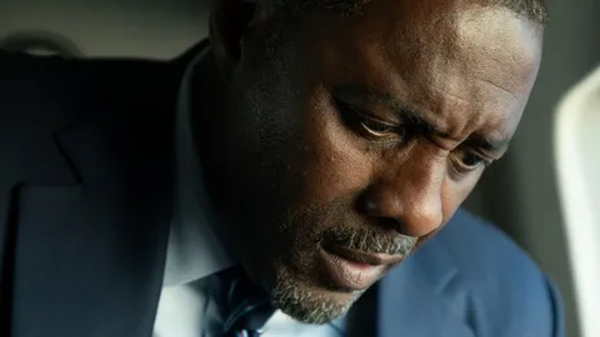Idris Elba in a suit, face in close-up