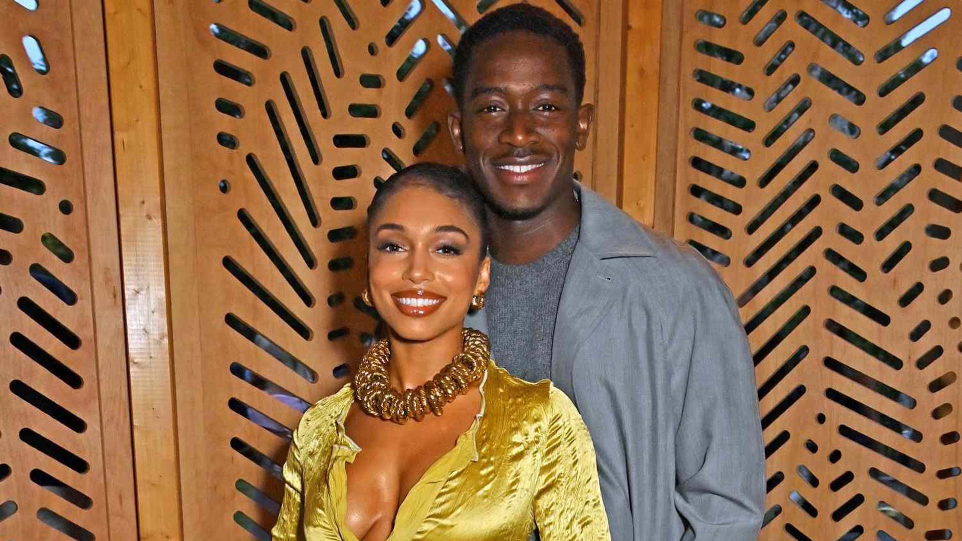 Damson Idris in a grey shirt and Lori Harvey in a yellow blouse