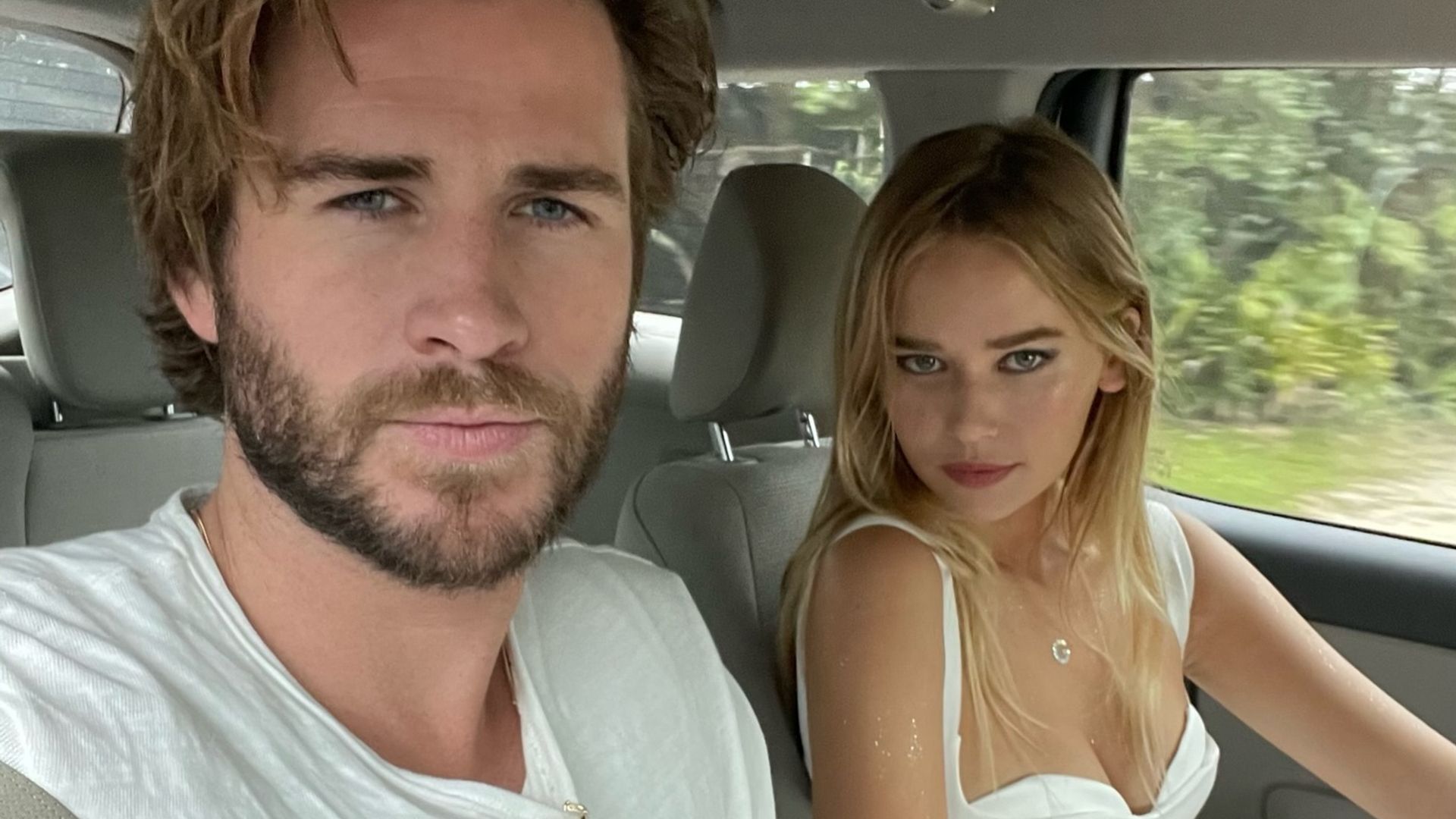 Liam Hemsworth and Gabriella Brooks taking a selfie in the car