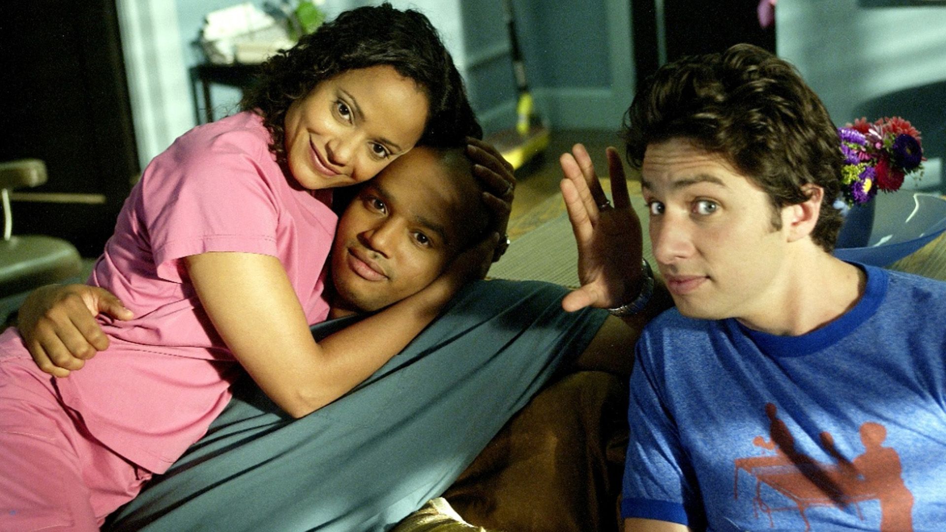 Judy Reyes hugs Donald Faison with Zach Braff sitting nearby