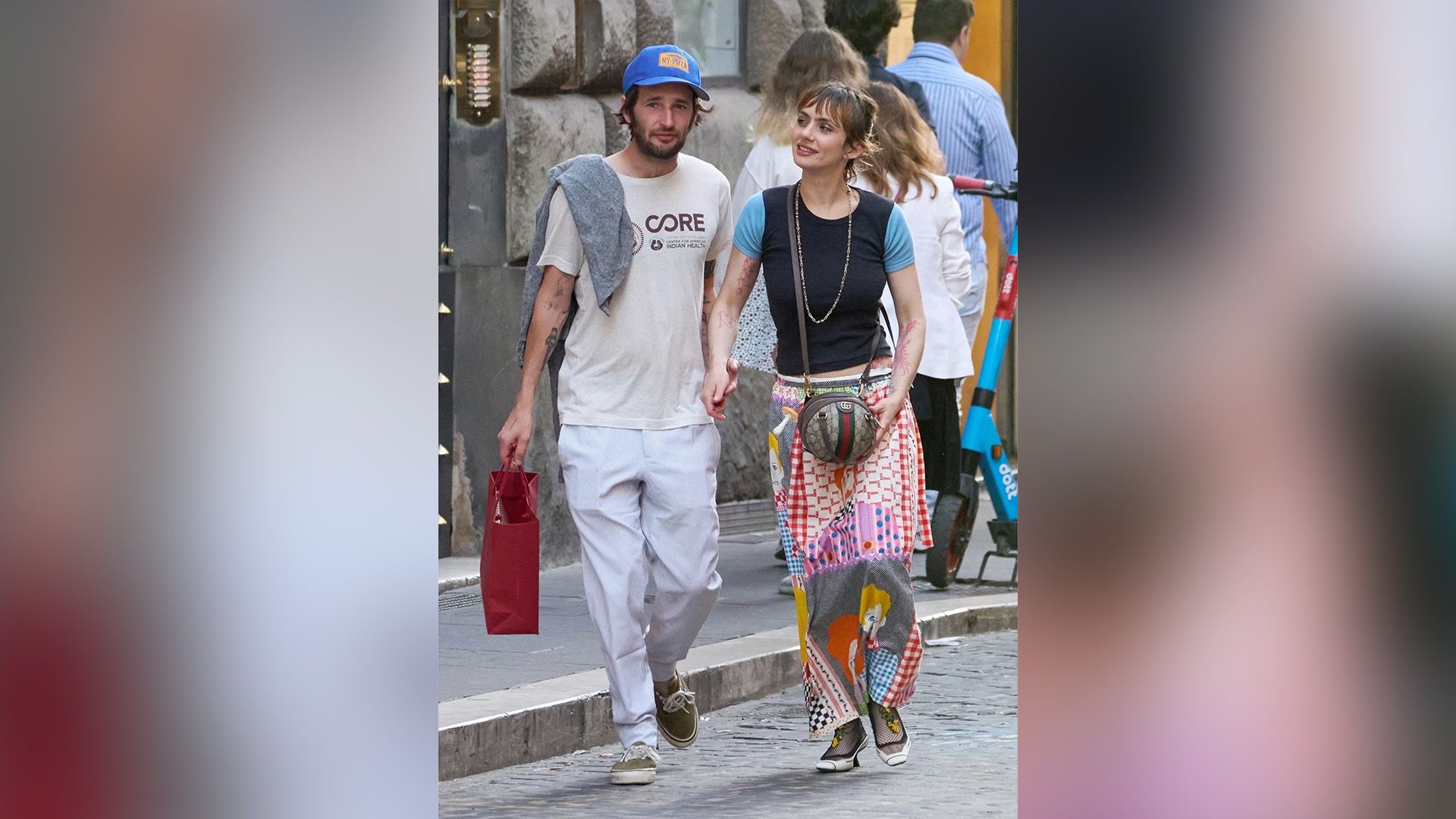 Zoe Bleu and Hopper Penn stroll down a city street, holding hands