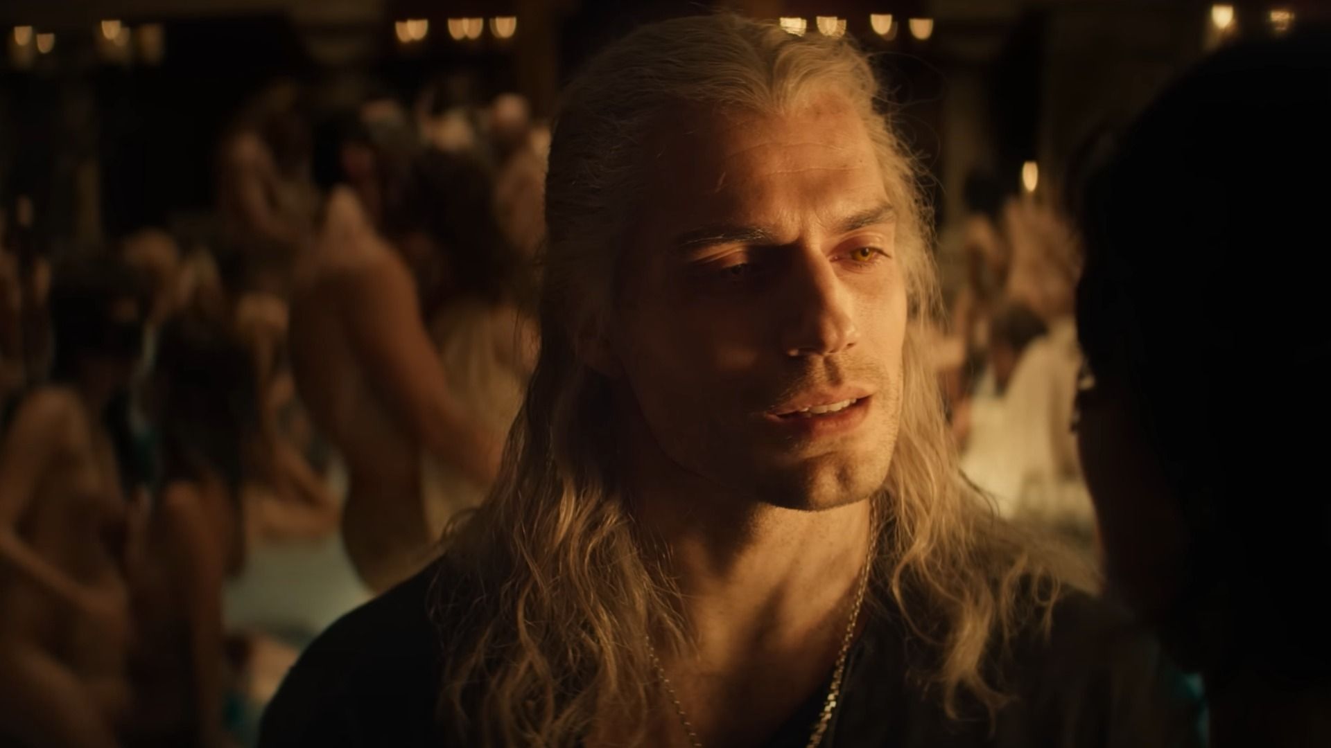 Actor Henry Cavill with long white hair wearing black clothing