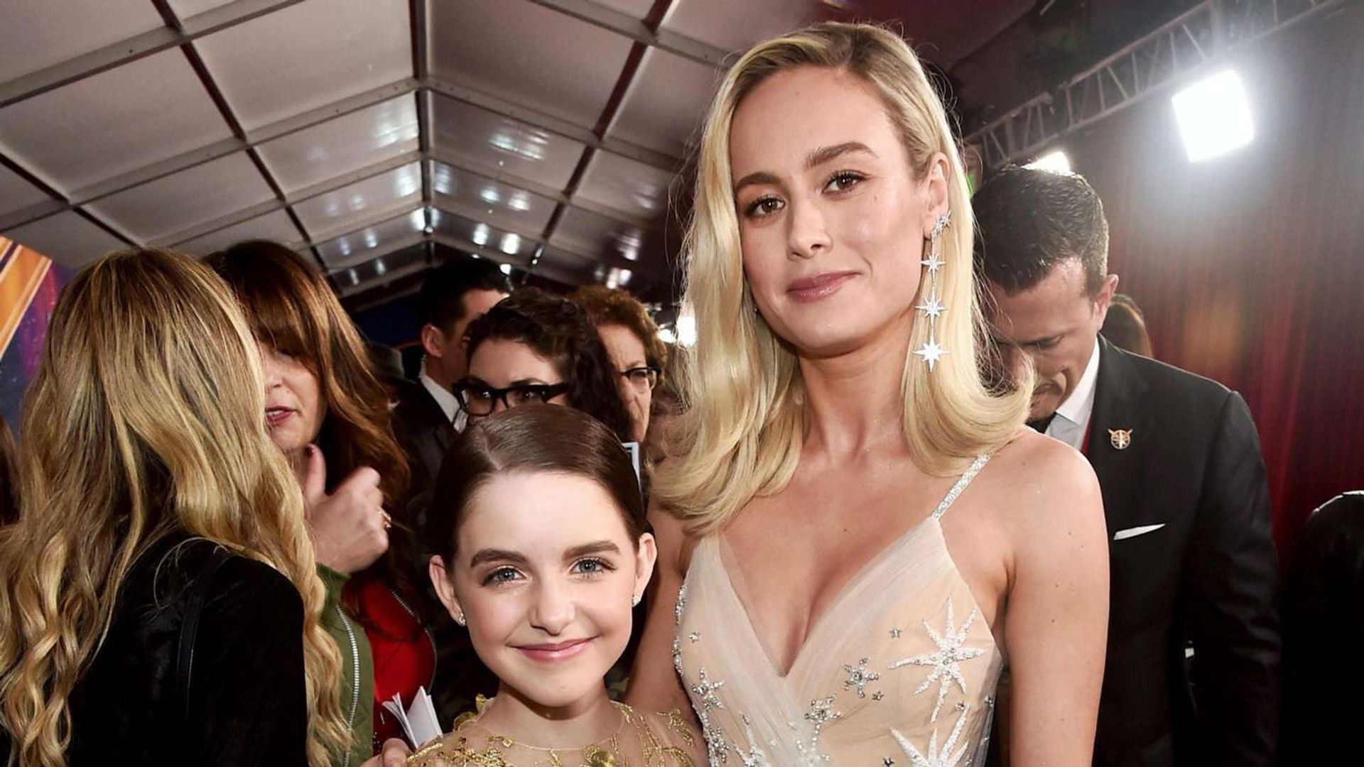 Mckenna Grace and Brie Larson pose together with Brie hugging the girl