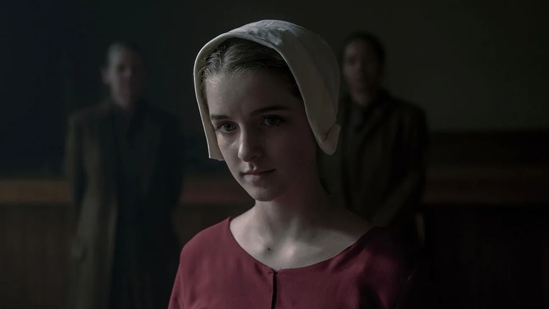 Mckenna Grace in a bonnet and period clothing, still from The Handmaid's Tale