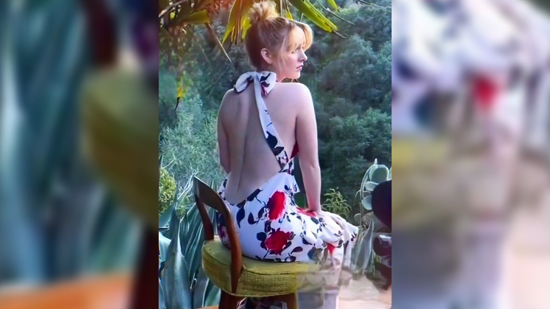 Mckenna Grace sitting in a backless dress, rear view