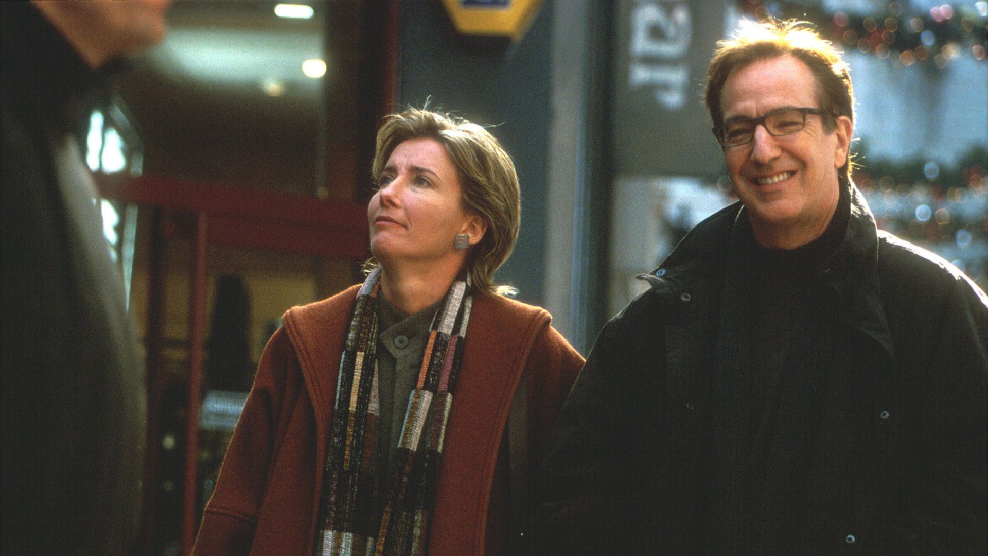 A smiling middle-aged man and woman walking down the street