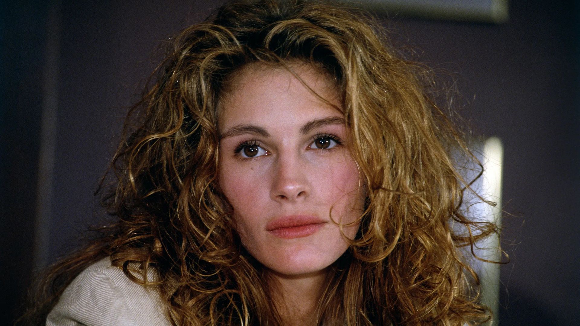 A young woman with long light curly hair