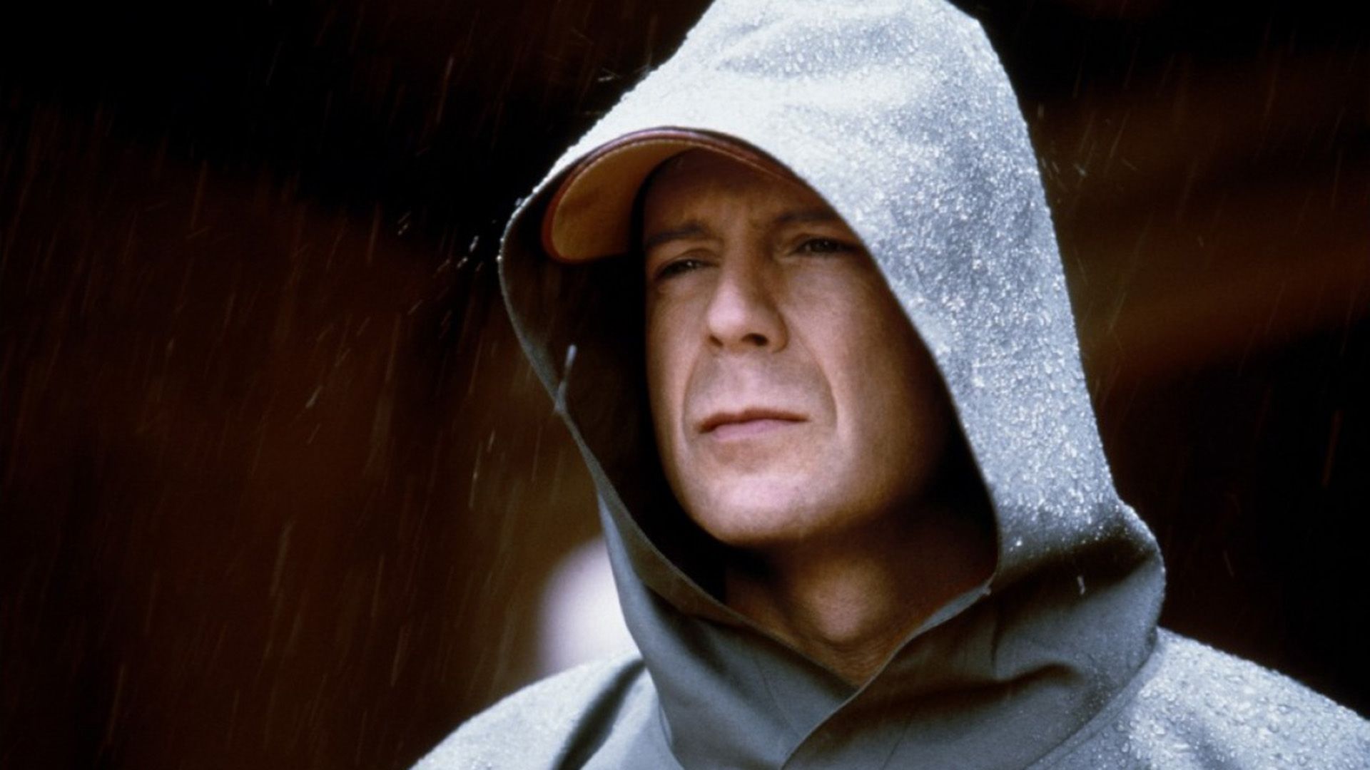 A man in a gray hoodie in the rain