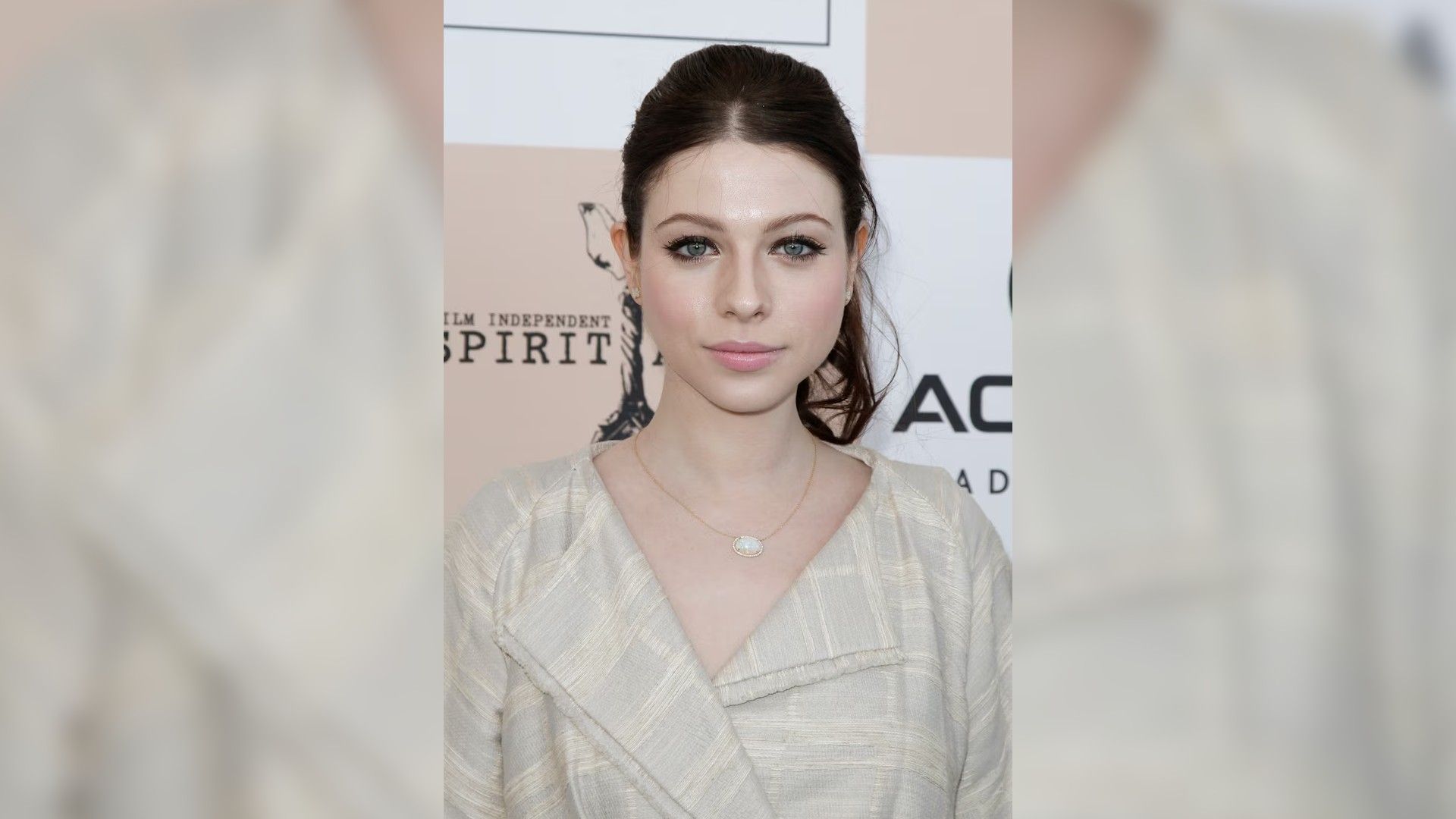 Michelle Trachtenberg in a white shirt, hair pulled back