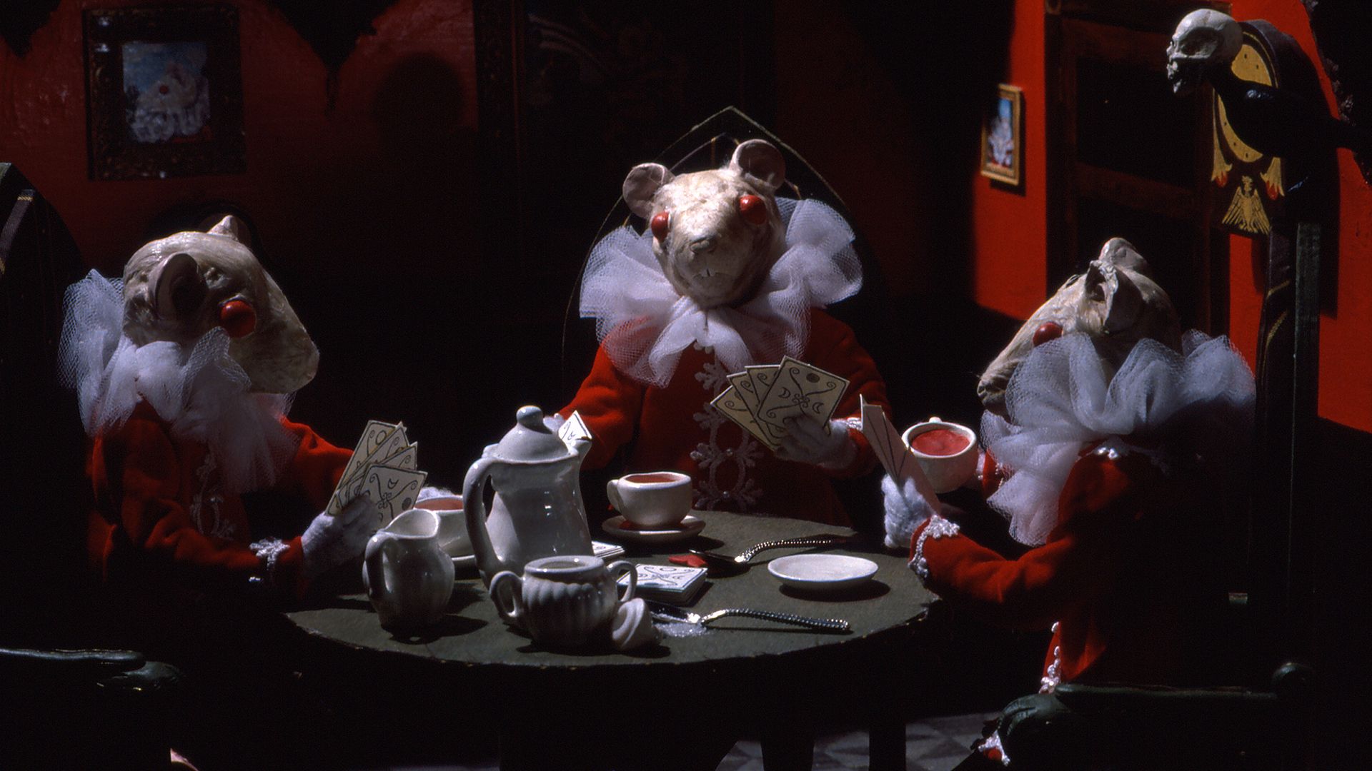 A frame from the cartoon "Blood Tea and Red String": three puppet mice are sitting at the table and playing cards