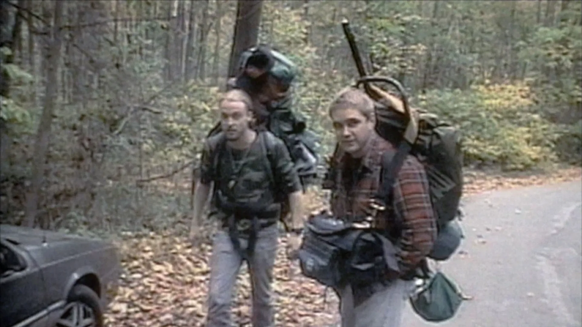 Amateur shooting, two men in hiking clothes with backpacks looking at the camera