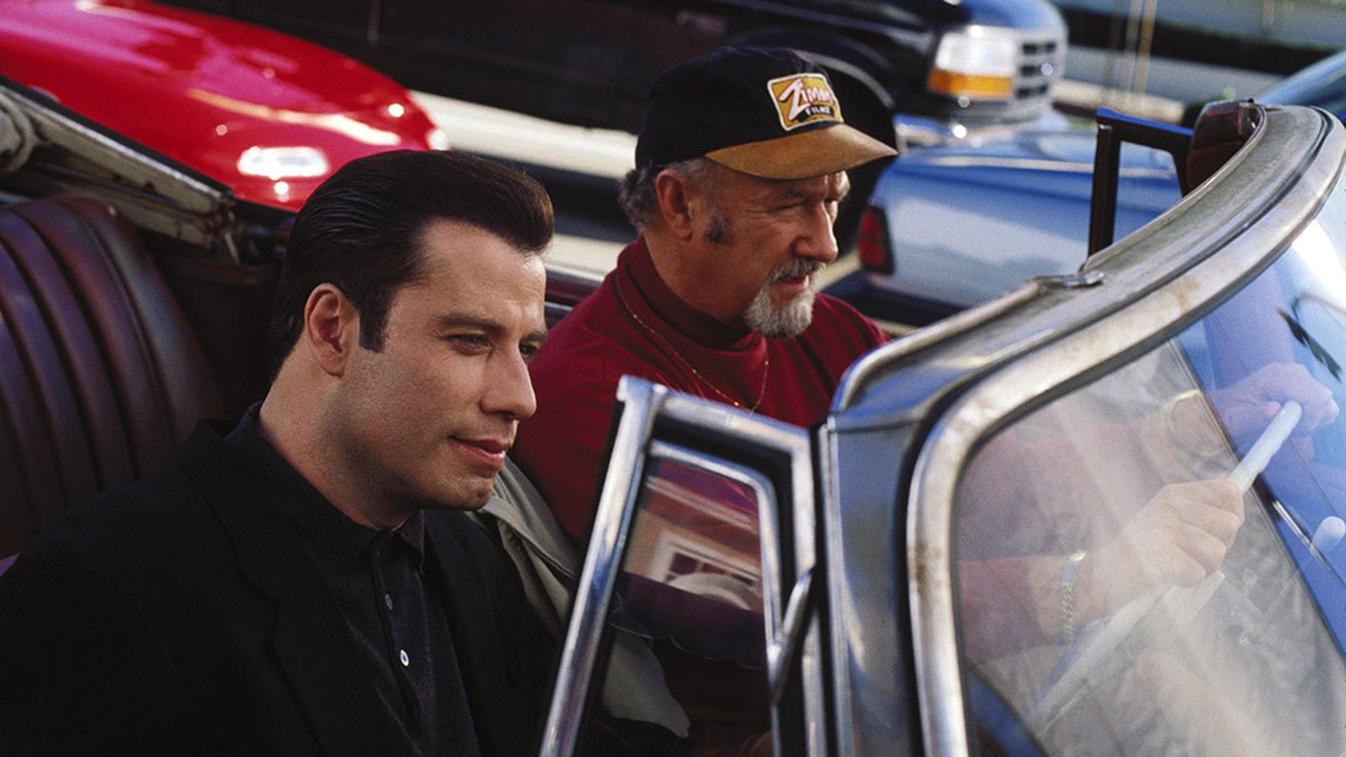 John Travolta and Gene Hackman in a red convertible in a scene from the film 'Get Shorty'