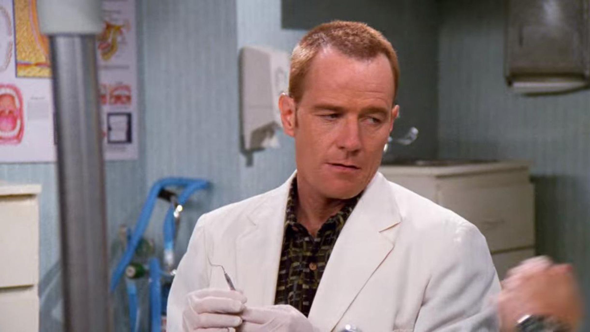 Bryan Cranston in a white coat in a scene from the series "Seinfeld"