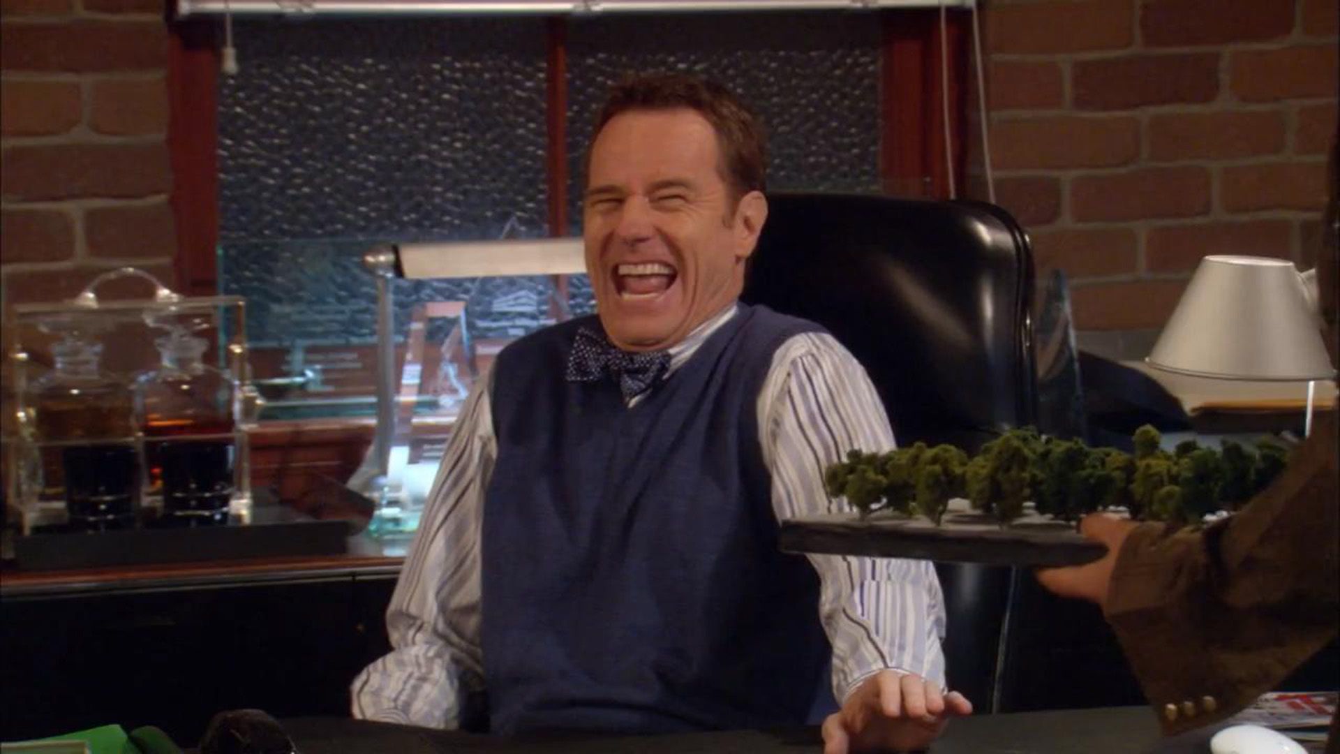 Laughing Bryan Cranston in a scene from the series 'How I Met Your Mother'