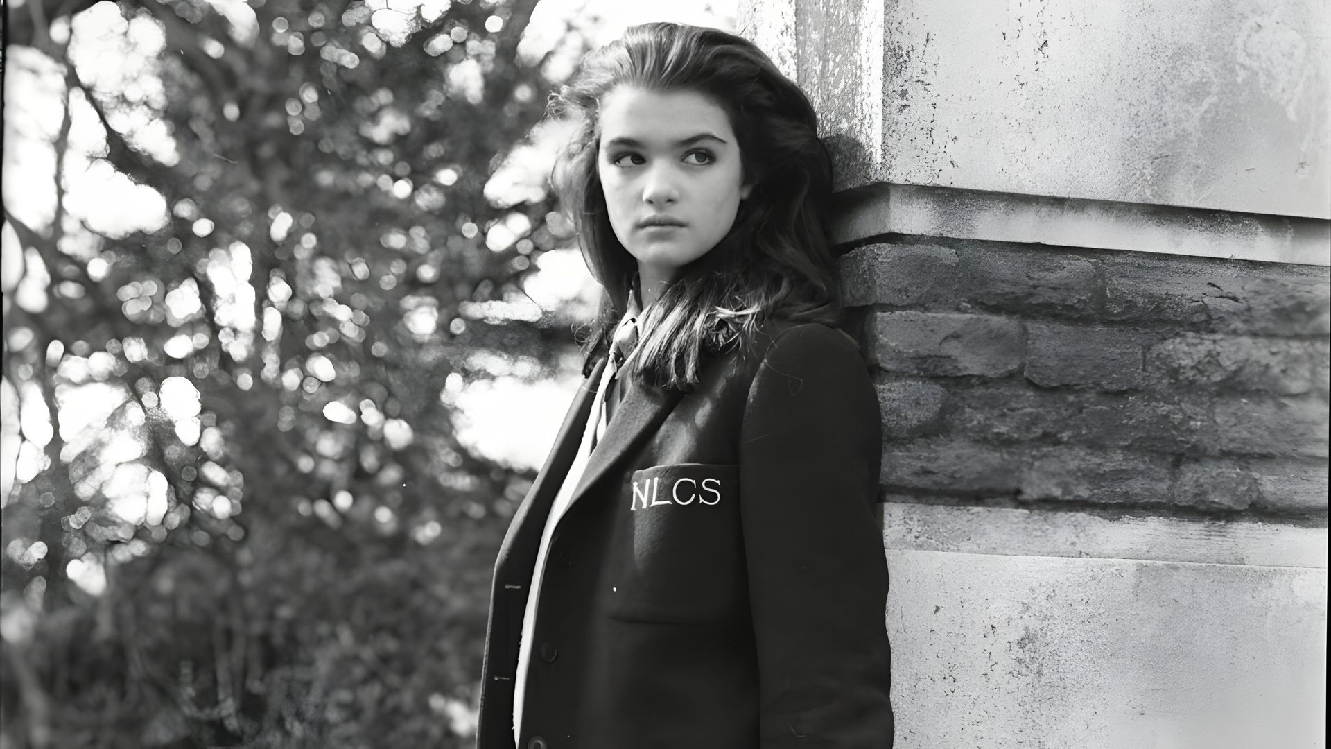 Black and white photo of a young girl dressed in a school uniform