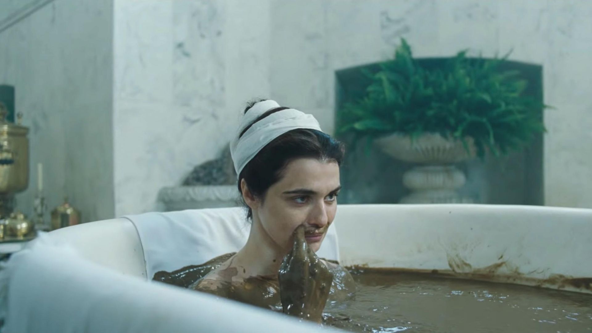 Rachel Weisz in the bath making herself a mustache out of dirt