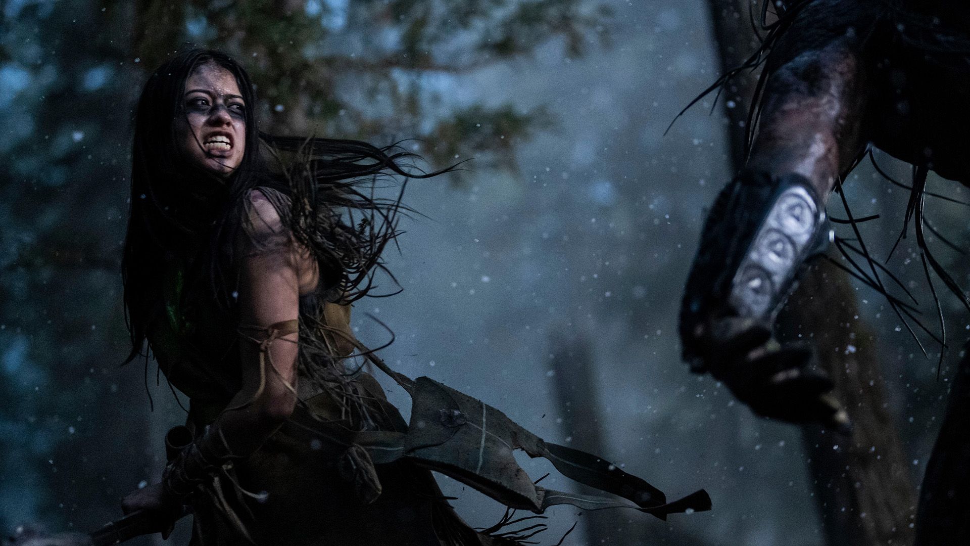 Amber Midthunder fights the Predator with rage on her face