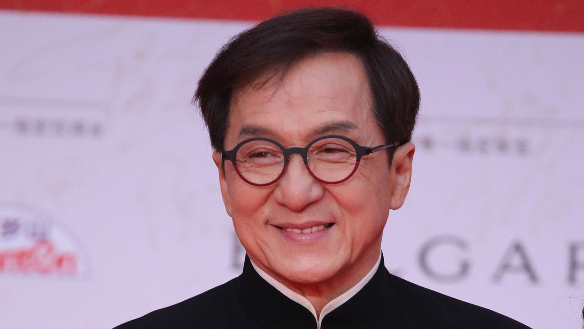 Actor and martial arts master Jackie Chan in round glasses close-up
