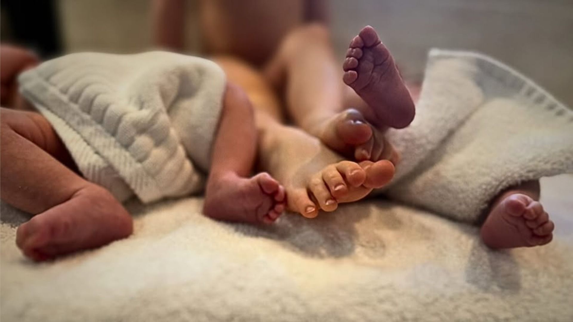 Three children of actress Amber Heard are lying on the bed covered with a blanket