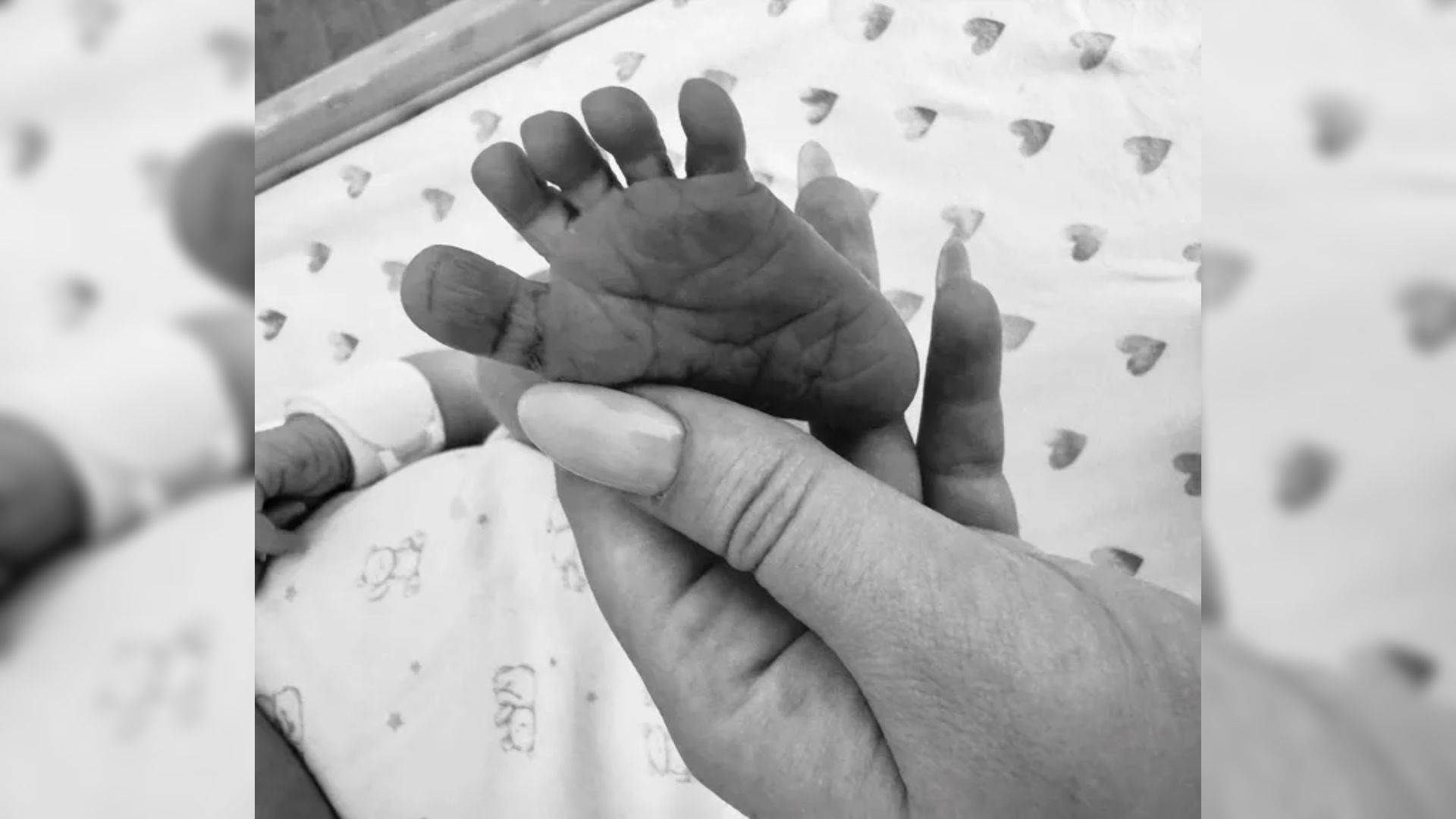Donald Trump's daughter Tiffany holds the tiny foot of her son, who is lying in the crib
