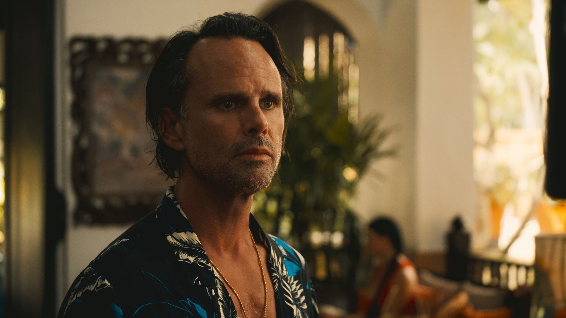 Walton Goggins in a Hawaiian shirt and with a gold chain around his neck