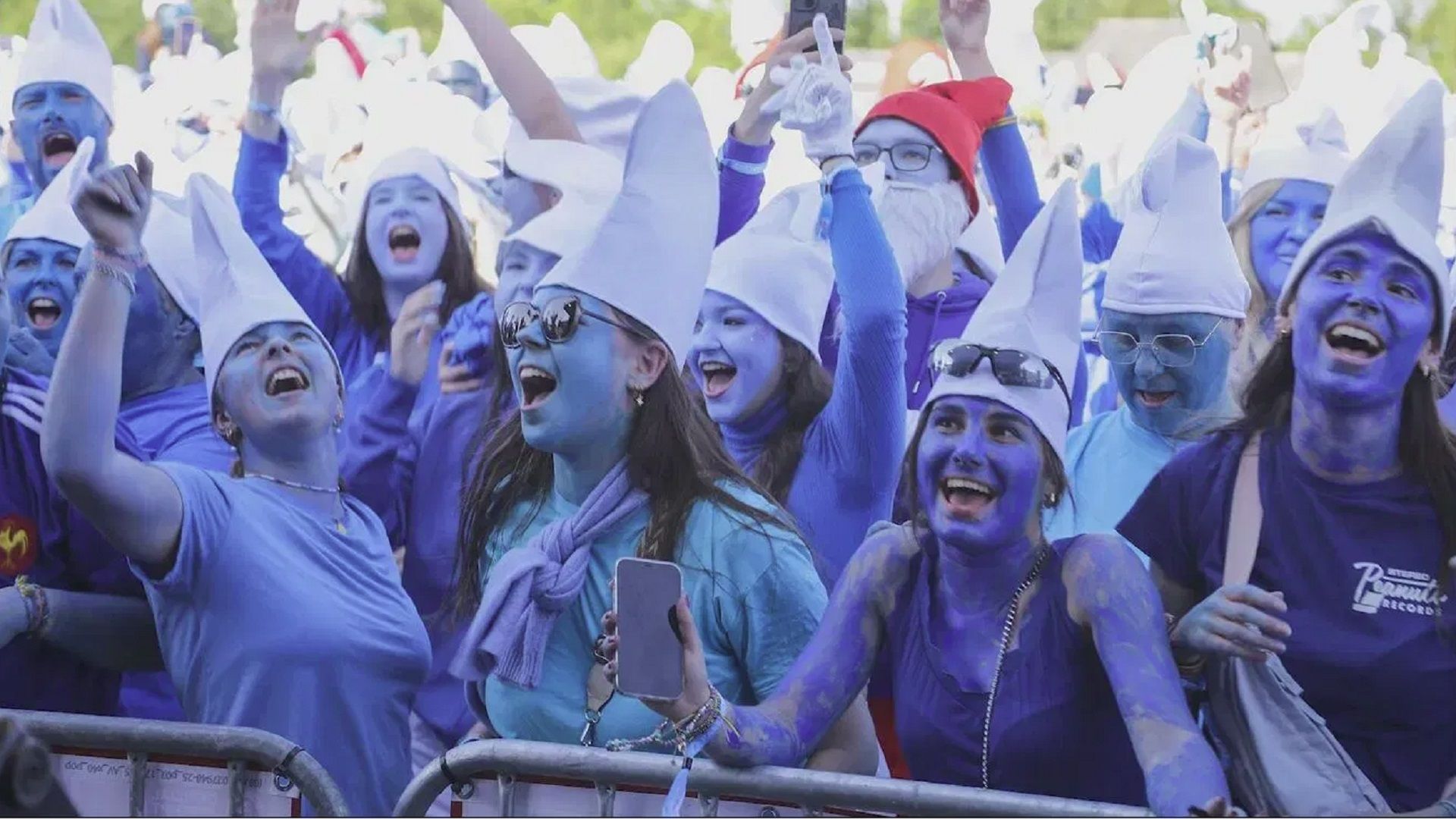People with blue faces in white hats celebrating the record